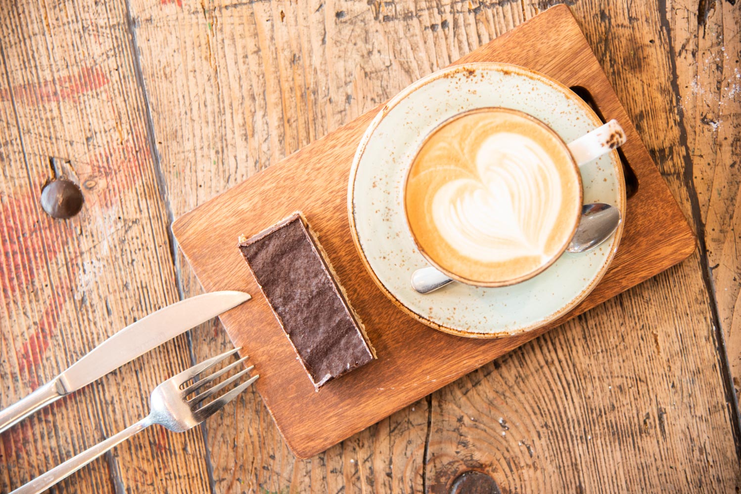 A promotional photo of coffee and slice from the café