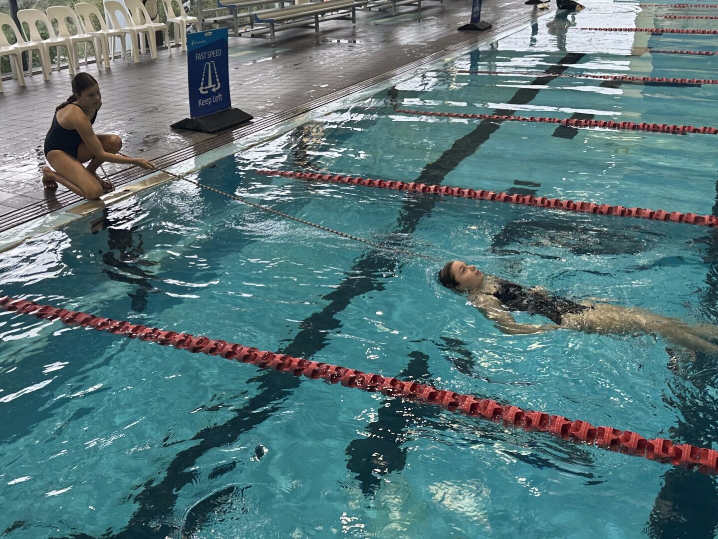 Surf Safety Girl being rescued in pool using a rope