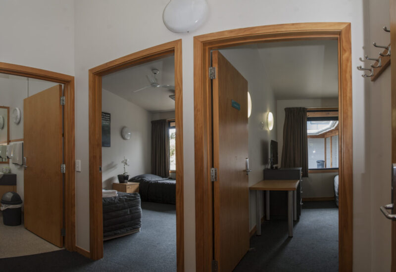 Two AUT Millennium Accommodation rooms and a bathroom, photo taken from the hallway