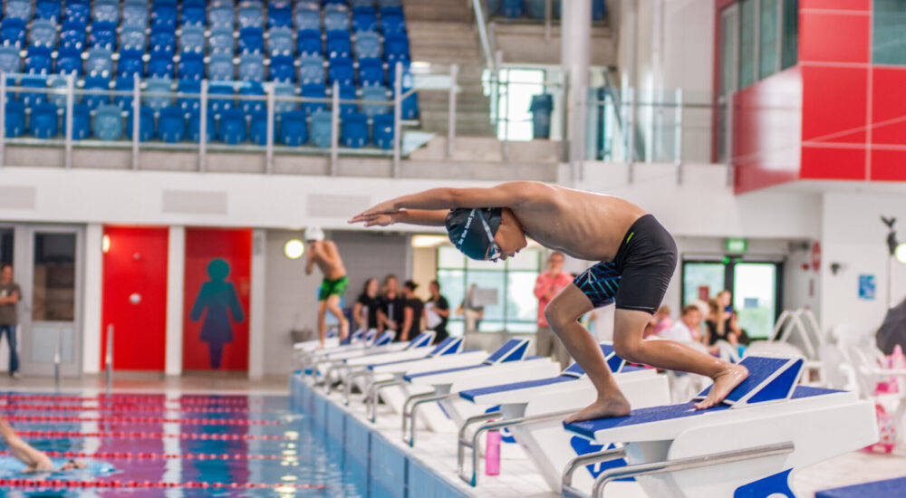 Swim School member practicing diving into the National Aquatic Centre Main Pool.