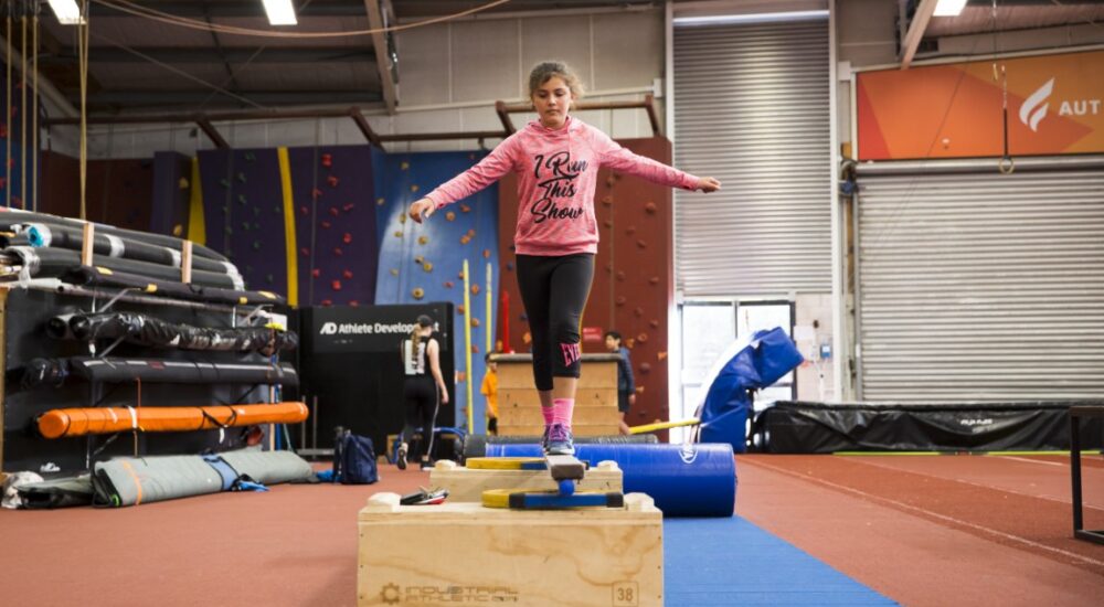 Athlete Development athlete walking across a balance beam