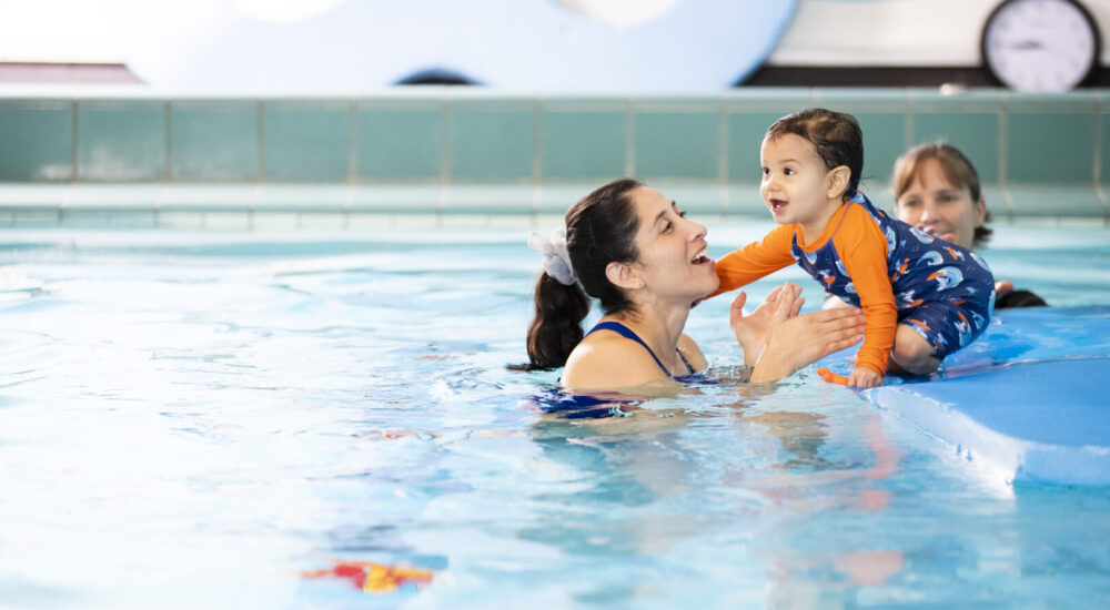 Mother with her baby participating in a Learn to Swim class in the Small Pool.