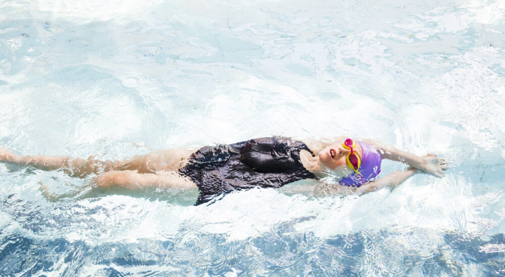 Swimmer practicing her backstroke streamline in the National Aquatic Centre Learner pool