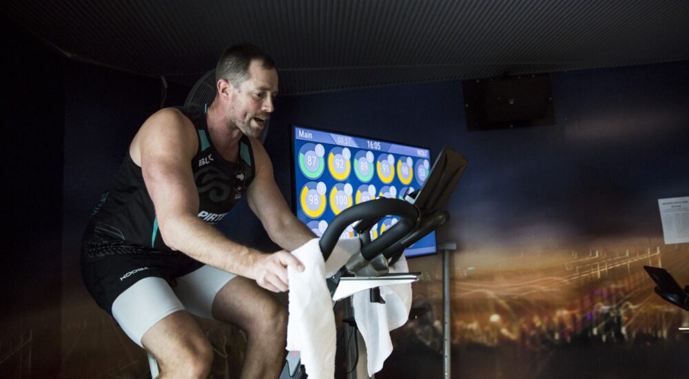 Spin instructor giving directions while on a spin bike